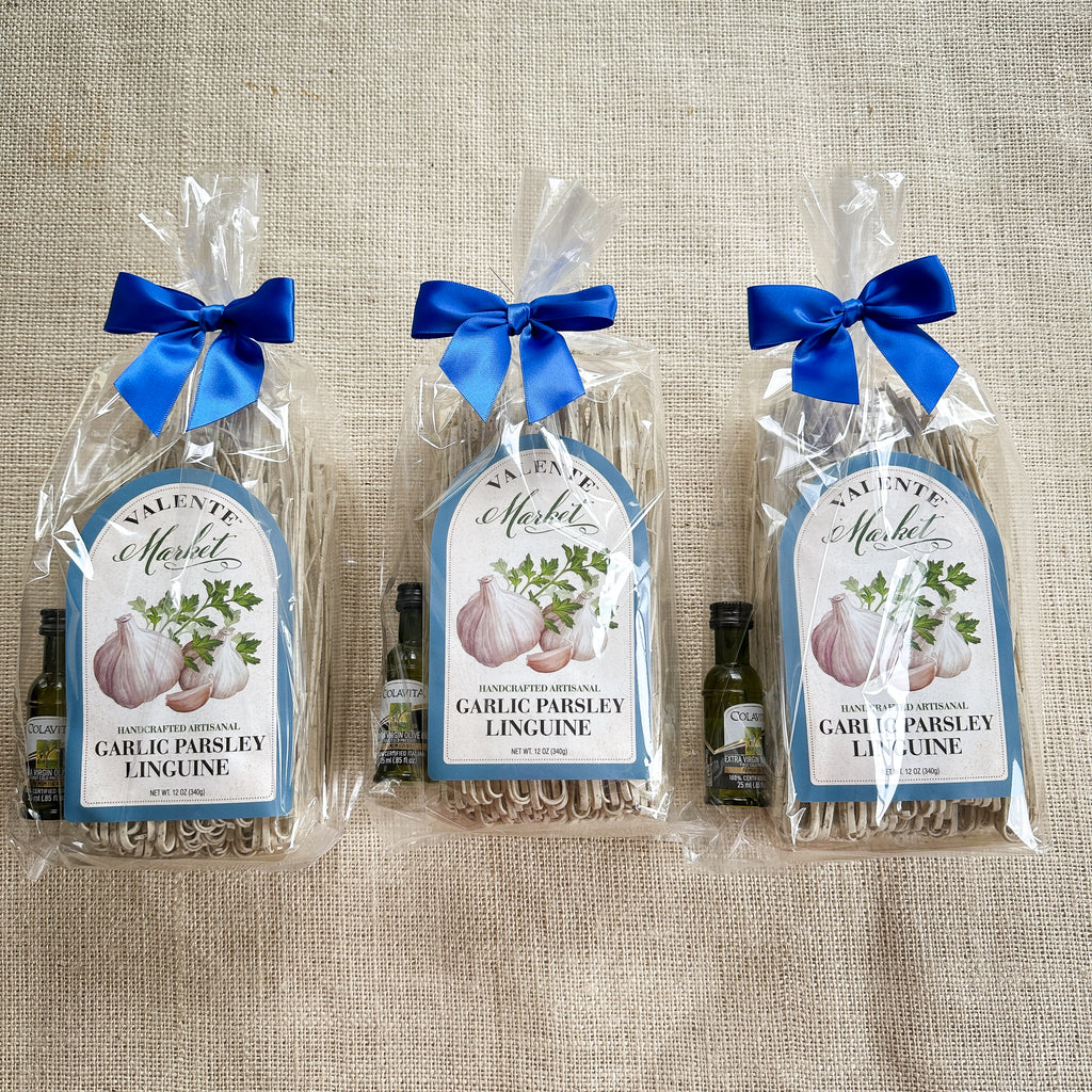 Three Gift Bags of Garlic Parsley Linguine tied with a bow and a mini bottle of olive oil