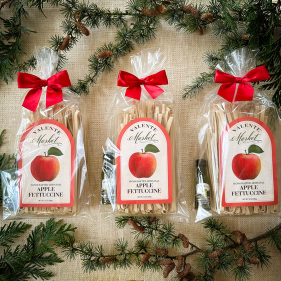 Three Gift Bags of Apple Fettuccine Gift Bags with a mini olive oil and tied with a red bow