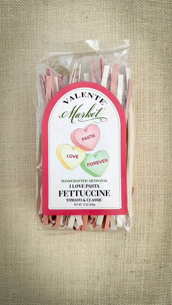 Packaged pasta with a decorative label on a textured beige background