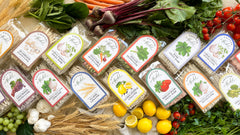 A range of pasta flavors showing colorful labels and  fresh vegetables