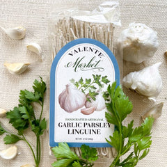 Garlic parsley linguine pasta in a clear bag with garlic and parsley and pale blue border on the label.