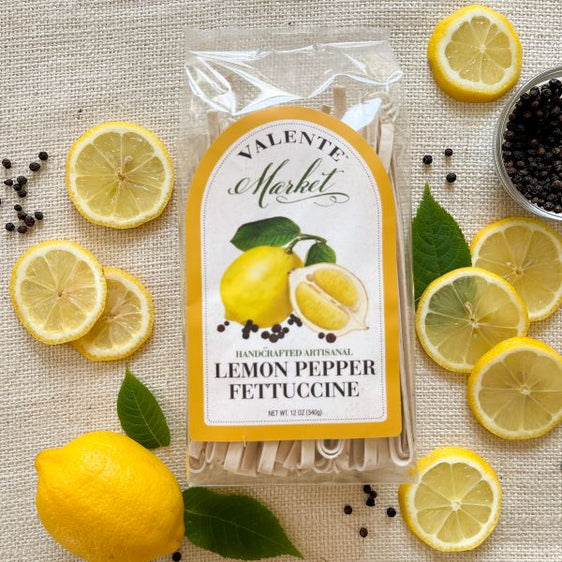 Lemon pepper fettuccine pasta in a clear bag with lemons and a bright yellow border on the  label