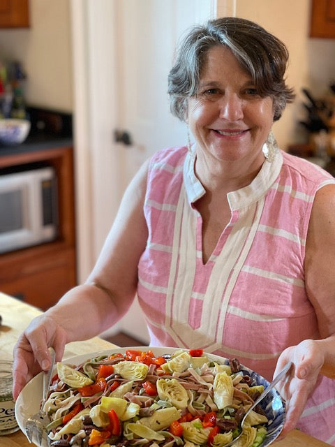 Mary Any serving a large pasta salad