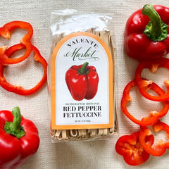 Red pepper fettuccine in a clear bag with red bell pepper  on the label with a pumpkin colored border