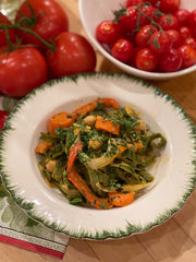 Spinach fettuccine vegetable recipe served in a white bowl with green rim