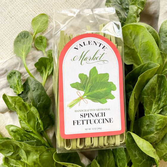 Spinach fettuccine in a clear bag, featuring fresh spinach and a red border on the label