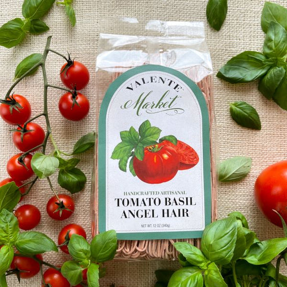 Tomato basil angel hair in a clear bag with fresh tomatoes, and basil and green border on the label 